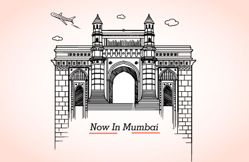image shows a graphic representation of gateway of India with a subtext- "Now in Mumbai"