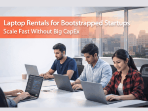 AI generated image showing Laptop Rentals for Bootstrapped Startups blog banner featuring a modern startup team working on laptops in an office, with an orange gradient overlay and the text “Scale Fast Without Big CapEx” displayed on the left.