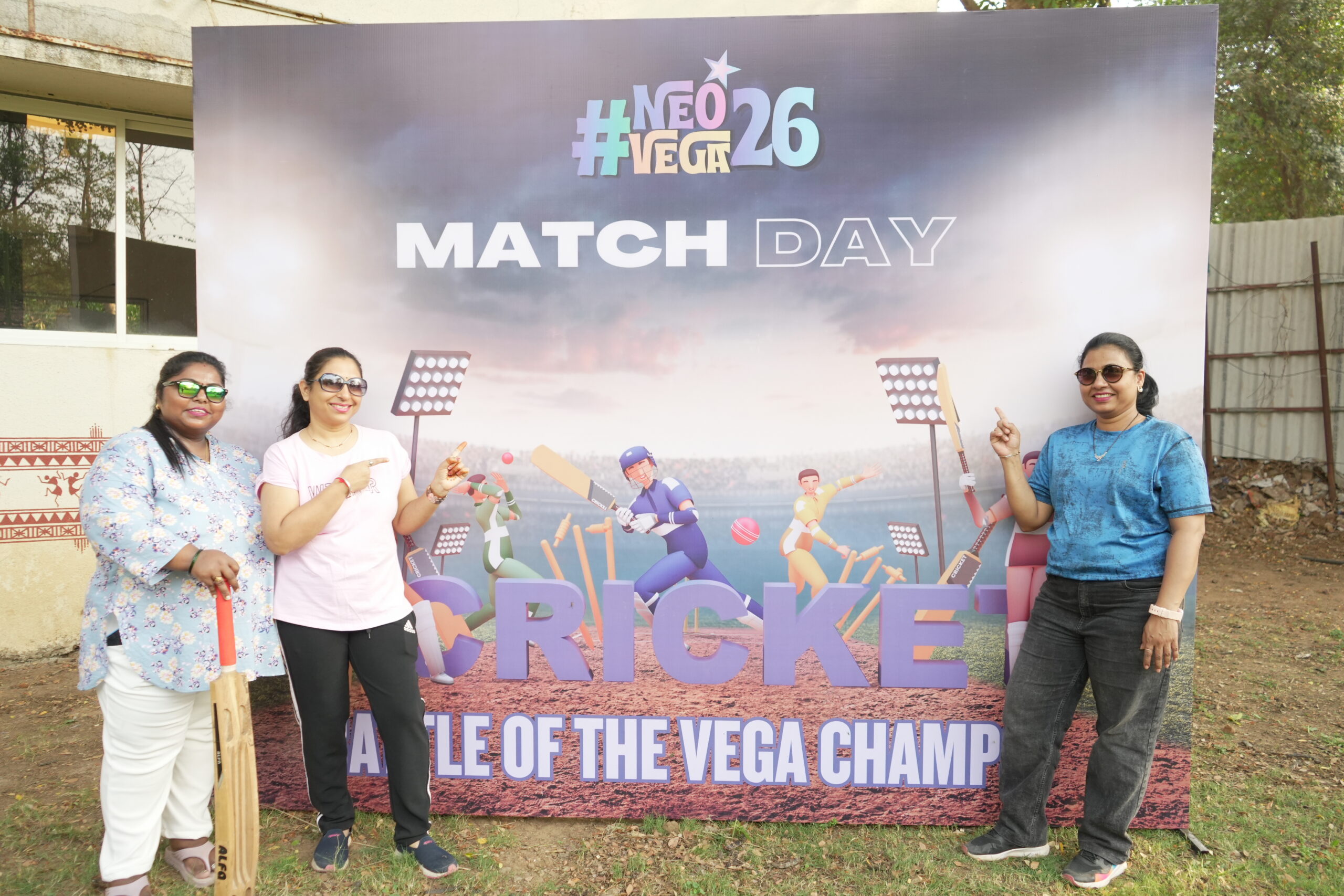 Rental Bunny team members posing near cricket themed event backdrop