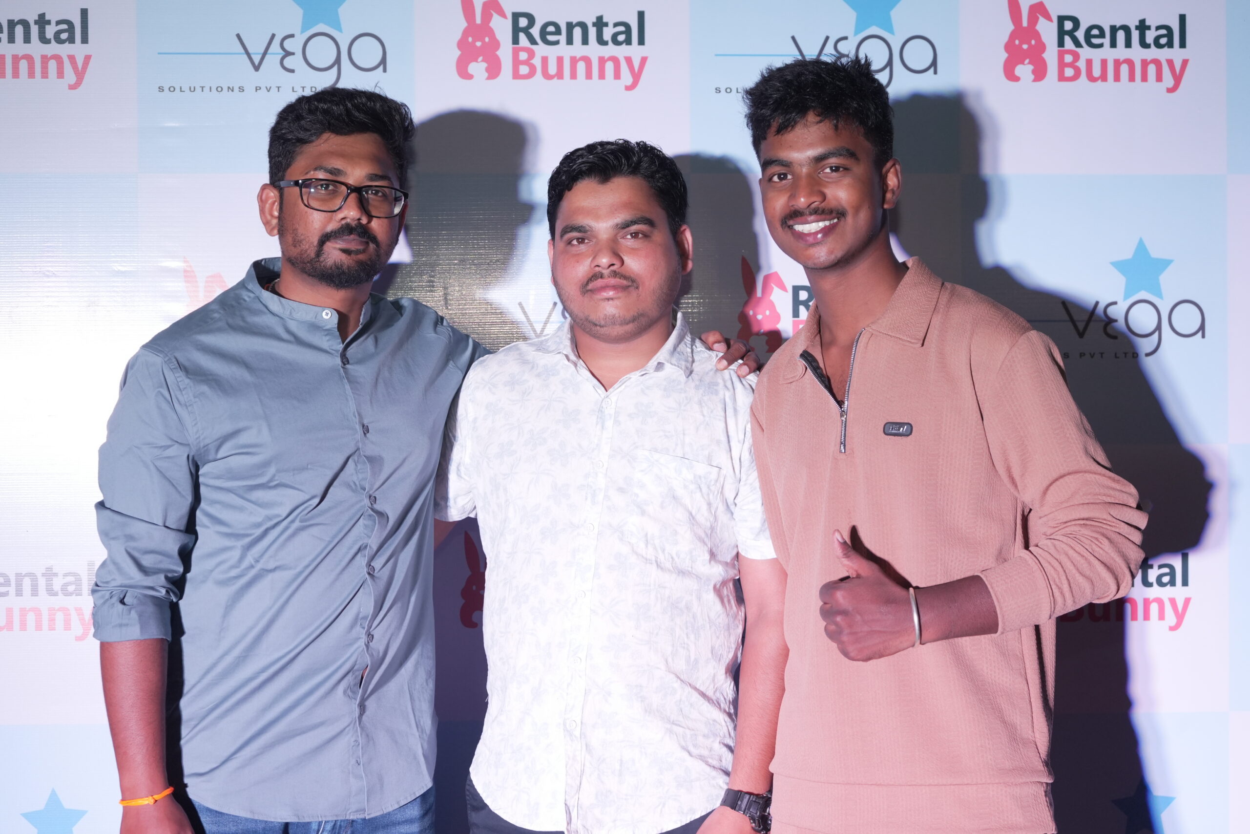 Rental Bunny team members posing at company event photo booth